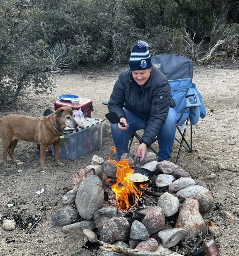 image represents danielle and amarillo cooking foood over firepit